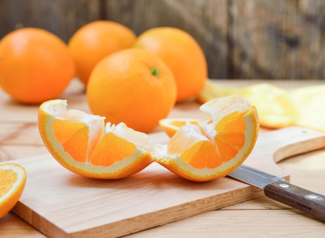 Peeling and unrolling oranges is easy on the cutting board.