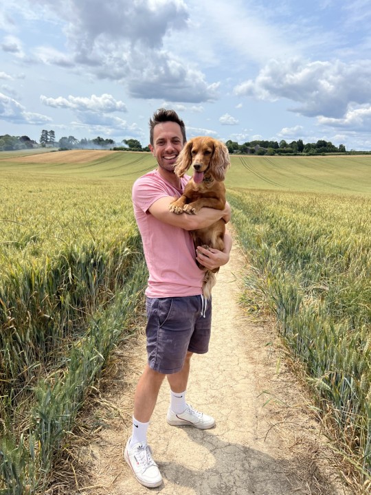 Nick Summerfield with his dog in the field 