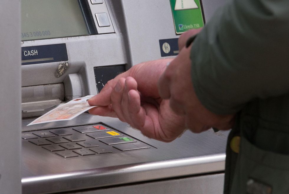 Man taking cash from cash point
