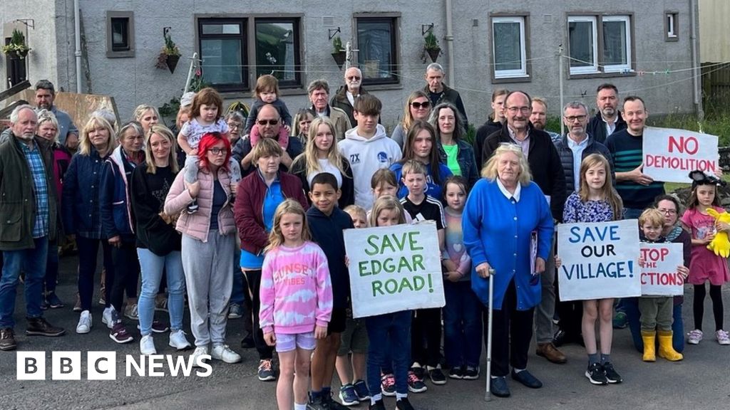 Neighbors rally against village eviction notice - BBC News